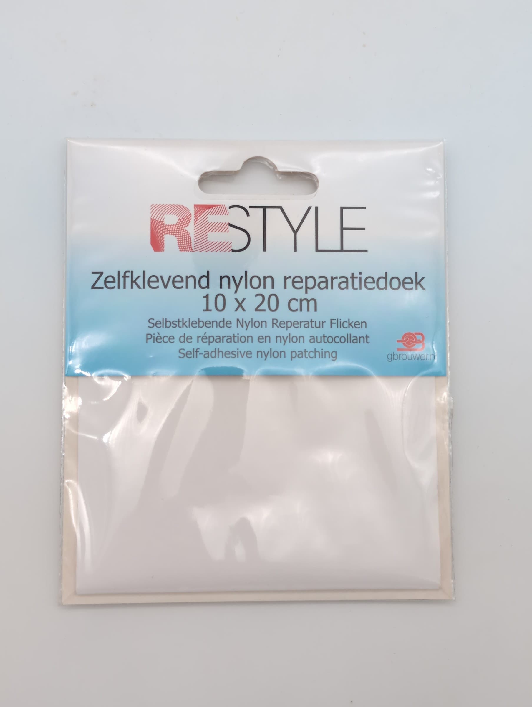 Restyle wit zelfklevend nylon reparatiedoek van 10 x 20 cm in verpakking, met gebruikspictogrammen en EAN-barcode